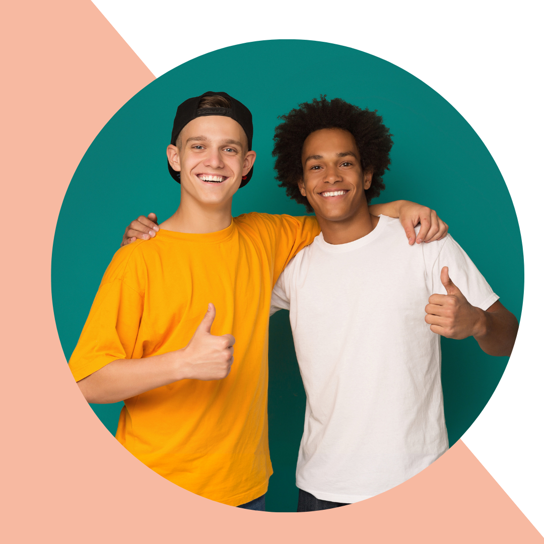 Image of two young adult boys with their hands on each other's shoulders and thumbs up